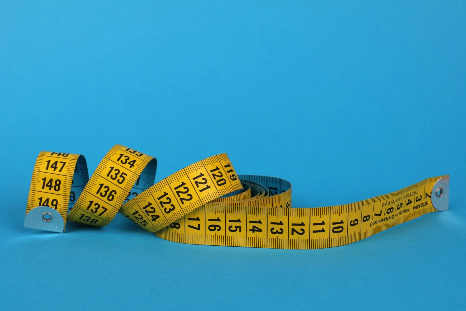 A tape measure extended across a piece of timber