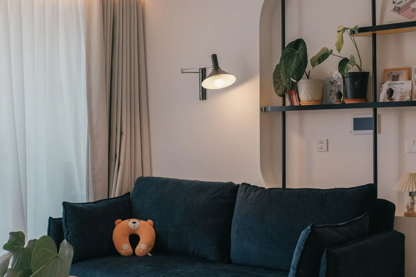 A living room with a television recessed into a fitted wall unit